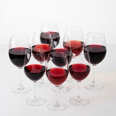 Various wine glasses with different red wines, showing color and body variations, on a clean background